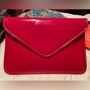 Red patent leather clutch purse.